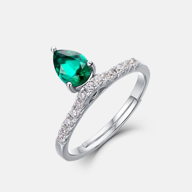 Origsoul engagement ring emerald cut with pear-shaped green gemstone and diamond band in silver