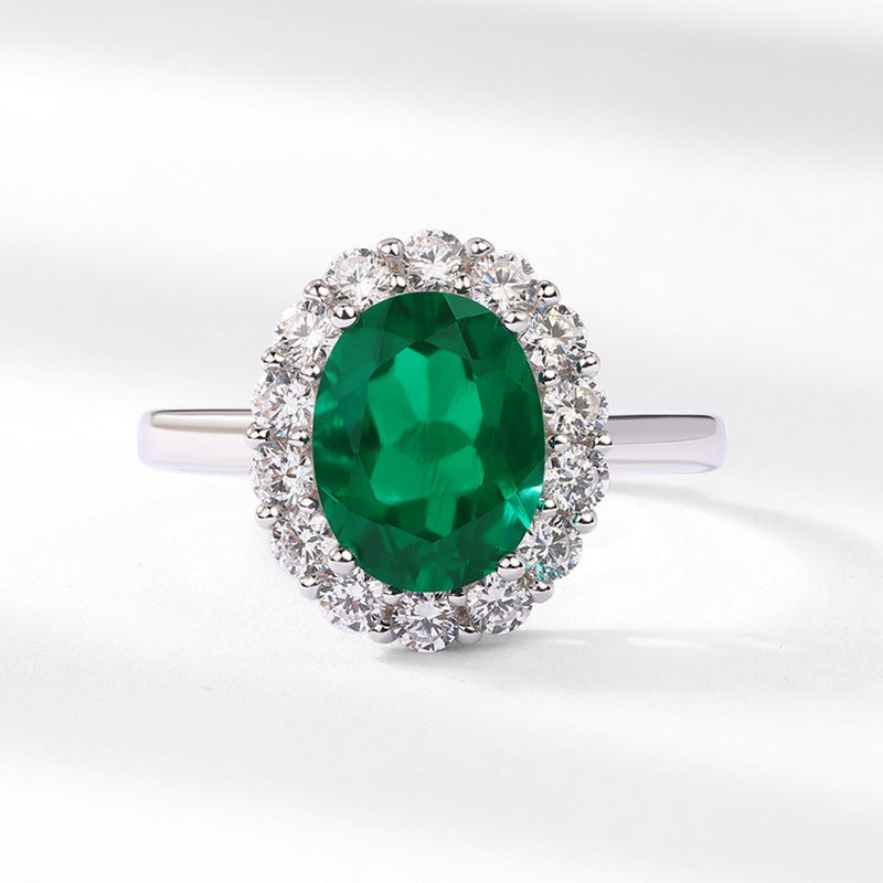 Origsoul engagement ring emerald cut with large oval green emerald surrounded by diamonds on silver band