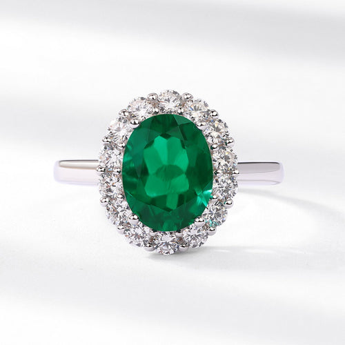 Origsoul engagement ring emerald cut with large oval green emerald surrounded by diamonds on silver band