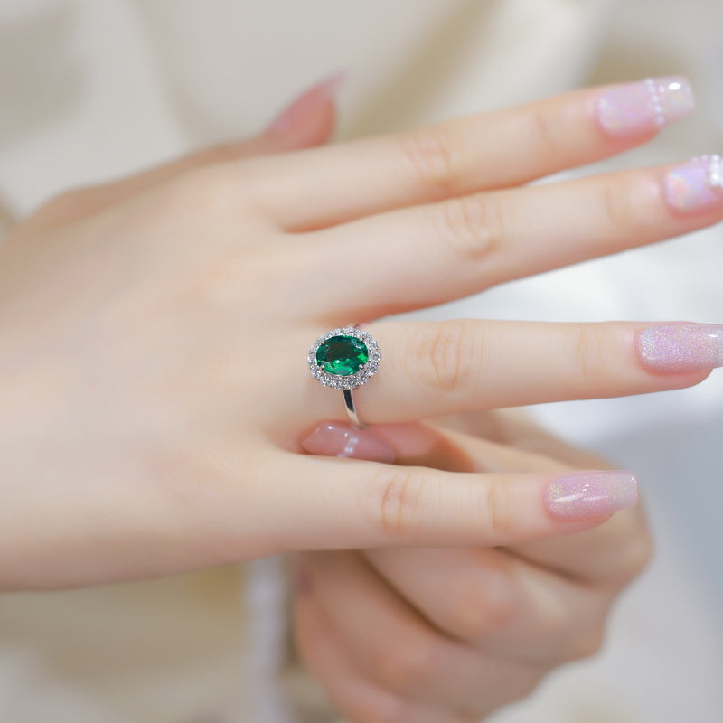 Origsoul engagement ring emerald cut with green gemstone and halo setting on hand