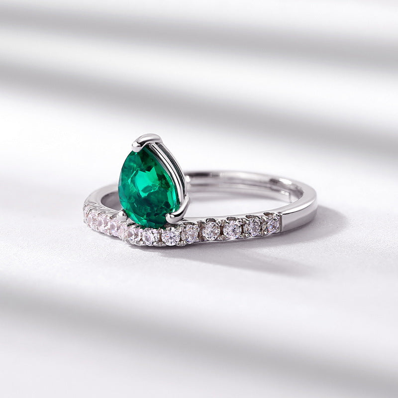 Origsoul engagement ring emerald cut with pear-shaped green gemstone and diamond accents on silver band