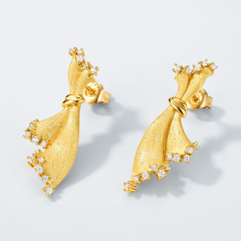Origsoul gold tone silver sterling silver earrings designed with bow shape and small crystal accents