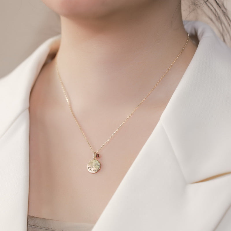 Origsoul delicate gold necklace birthstone pendant worn with white blazer