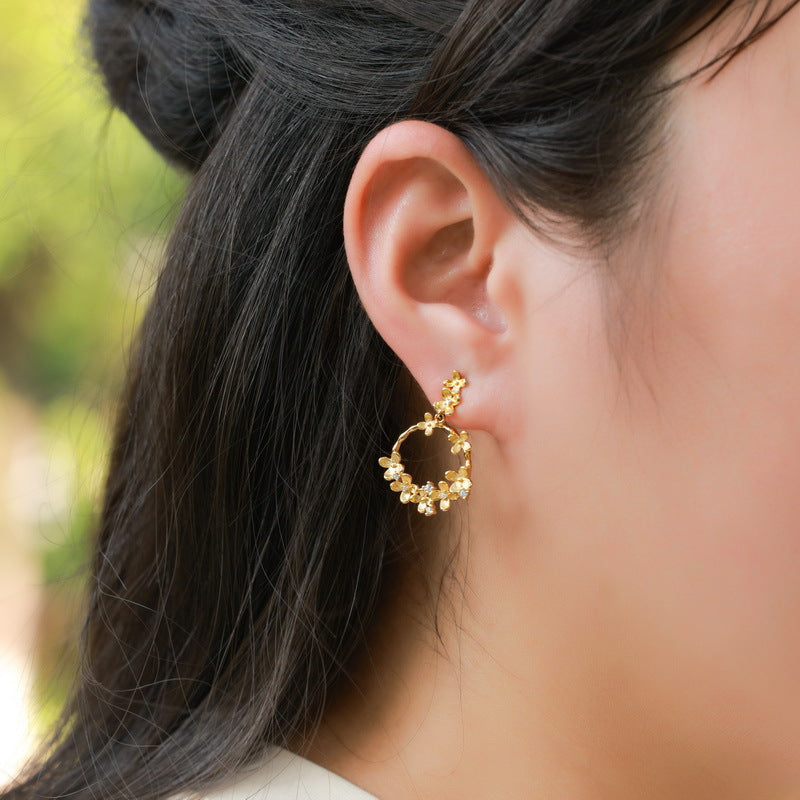 Origsoul silver earrings sterling gold tone floral hoop worn on woman's ear