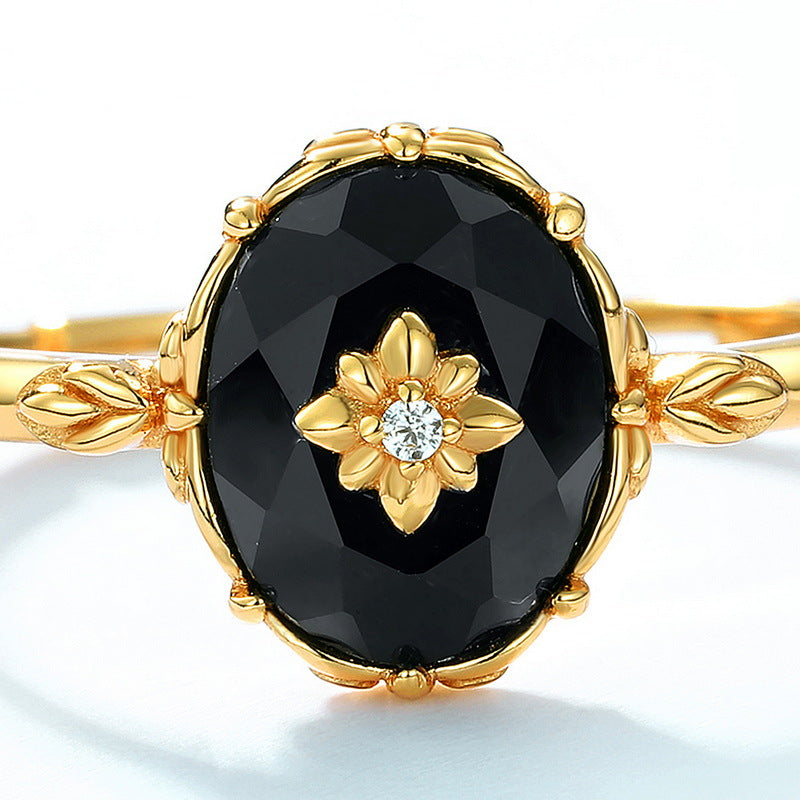 Origsoul silver sterling ring with large black gemstone and gold floral design centerpiece