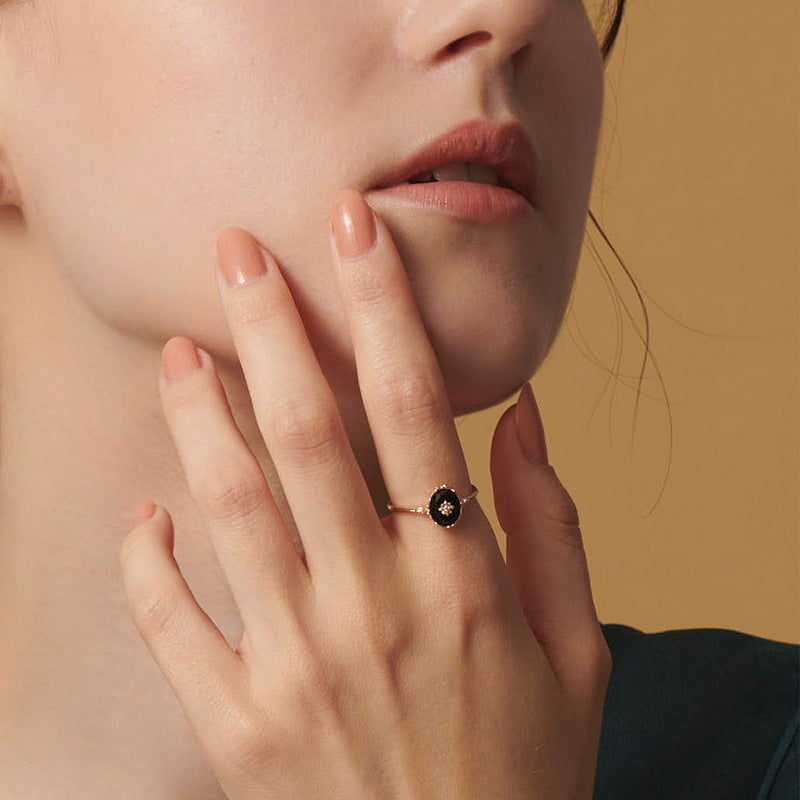 Origsoul silver sterling ring with black oval stone worn on female hand near face