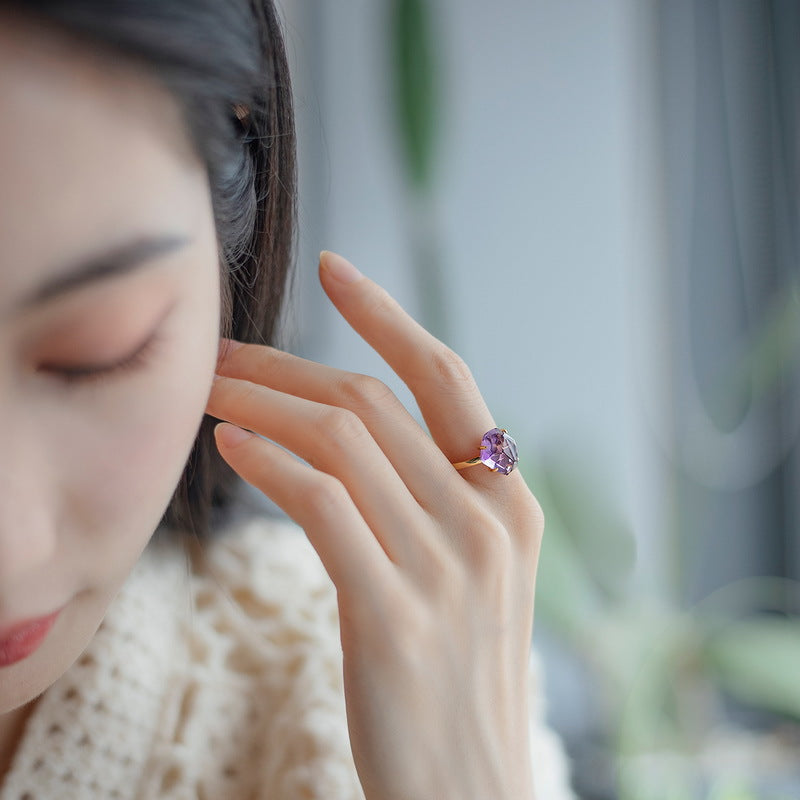 Origsoul ring sterling silver with purple gemstone worn on hand with soft natural background