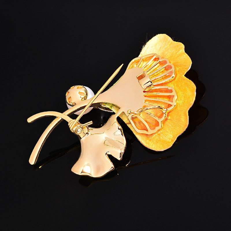 Origsoul gold-tone ginkgo leaf tree brooch with detailed textured design on black background