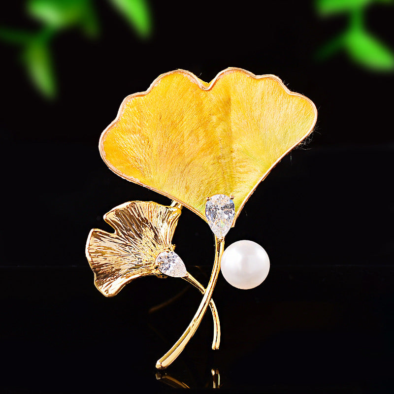 Origsoul elegant brooch with gold ginkgo leaf tree design and pearl accent on black background