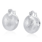 Origsoul hand-drawn silver earrings with textured finish and rounded hoop design