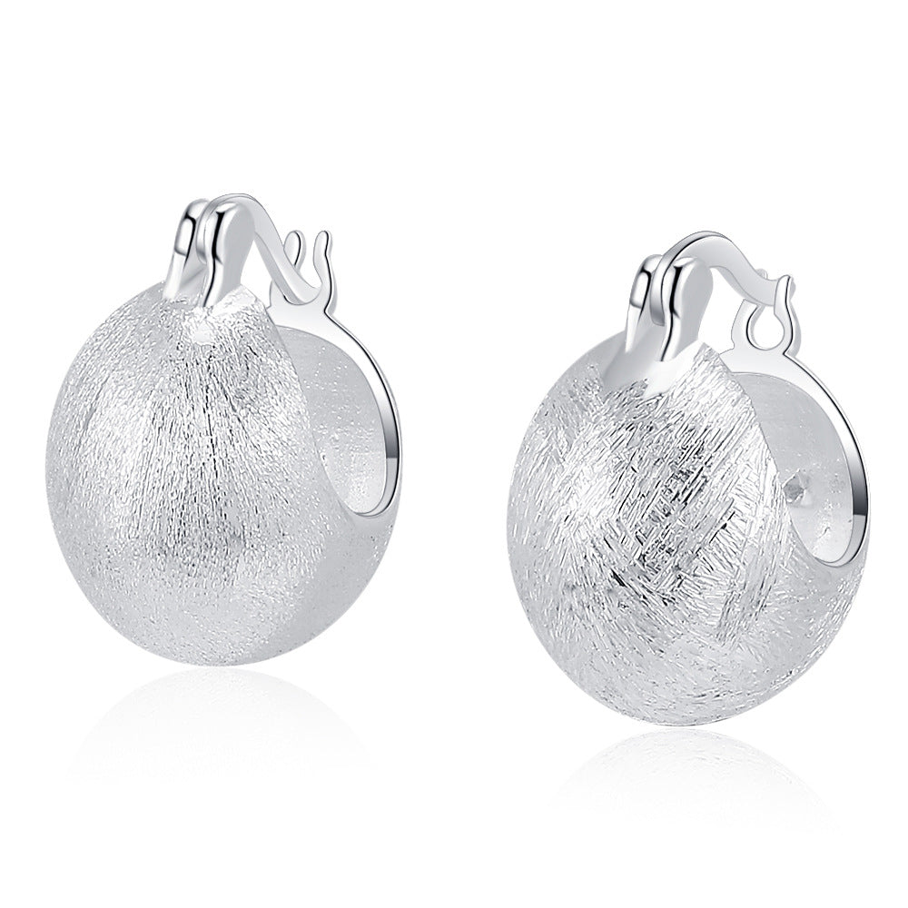 Origsoul hand-drawn silver earrings with textured finish and rounded hoop design