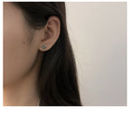 Origsoul June birth flower earrings worn on ear in delicate floral design