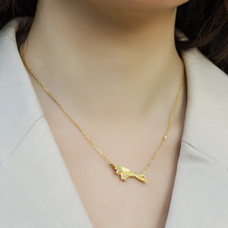 Origsoul gold fish pendant silver necklace sterling styled on model with beige blazer