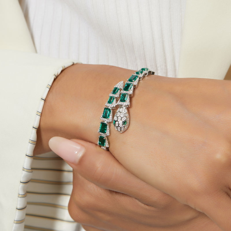 Origsoul bracelet sterling silver with green gemstones worn on wrist with white sleeve