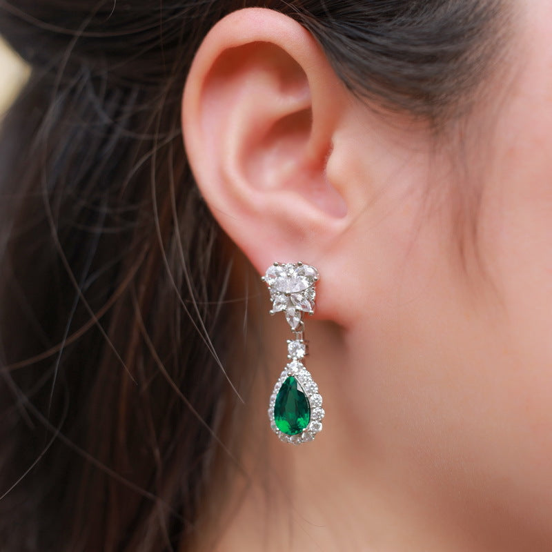 Origsoul sterling silver earrings with green teardrop gemstone and clear crystals on ear