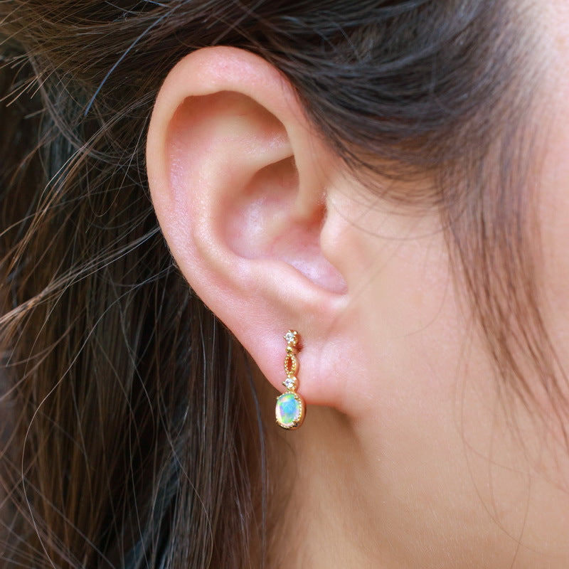 Origsoul sterling silver hoop earrings with opal gemstone dangling design on ear