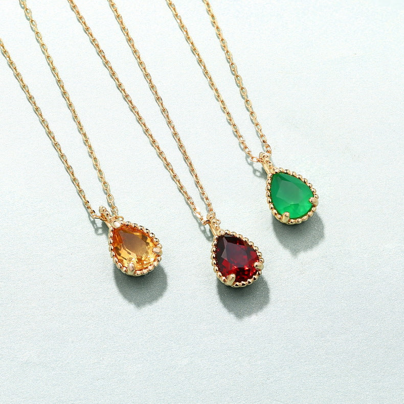 Three gold chain necklaces with teardrop-shaped pendants in orange red and green men's silver cross pendant style
