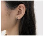 Origsoul cosmic twisted style earrings for women worn on ear with delicate cosmic design