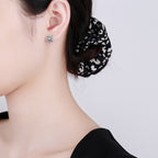 Origsoul cosmic sun and moon stud earrings worn on ear with black and white hair scrunchie