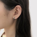 Origsoul cosmic jewelry twisted style earrings for women worn on ear with black hair