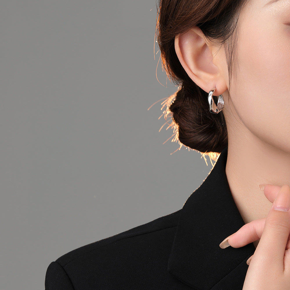 Origsoul modern bumpy hoop earrings worn on ear showcasing unique textured silver design