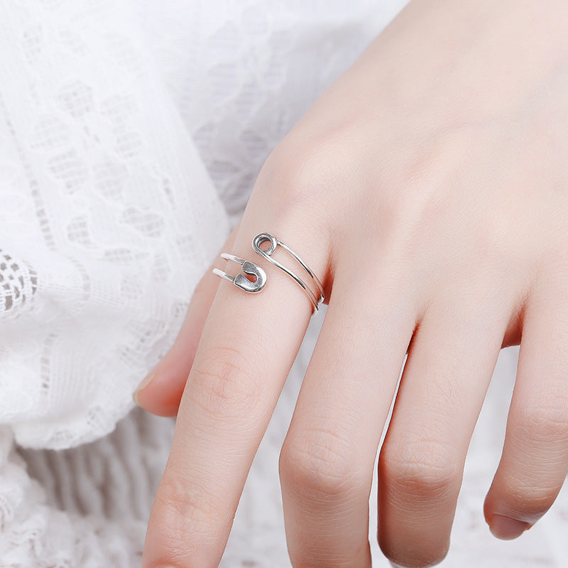 Origsoul modern silver statement ring designed like a safety pin worn on a finger