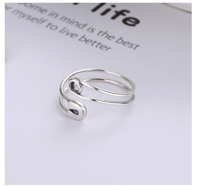 Origsoul modern silver statement ring with unique open spiral design on white background