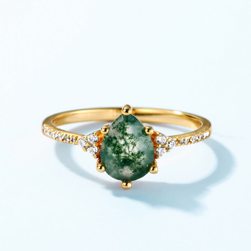 Origsoul gold ring with pear-shaped moss agate ring stone and small side diamonds
