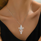 Origsoul Nana heart cross necklace in silver worn on neck with black top
