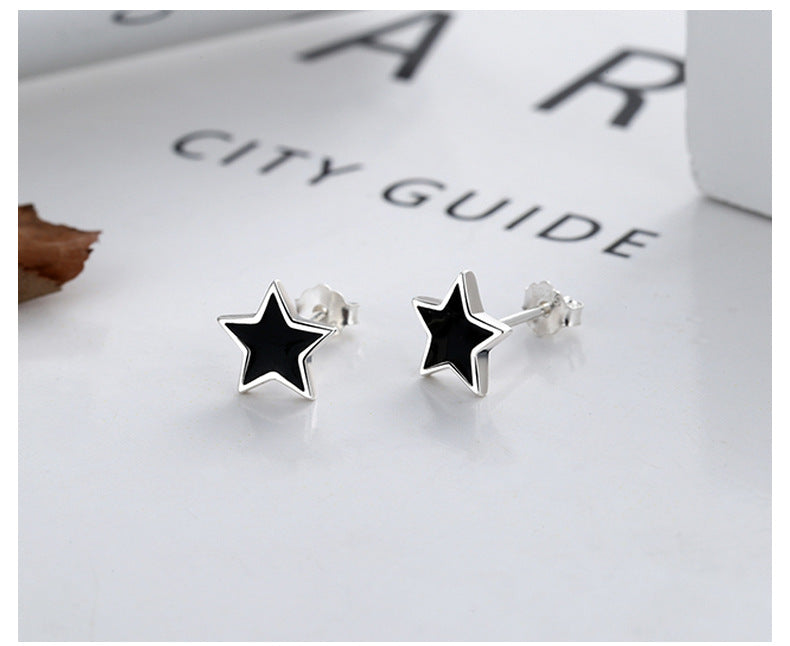 Origsoul black and silver nautical star stud earrings with sleek cosmic design on white background