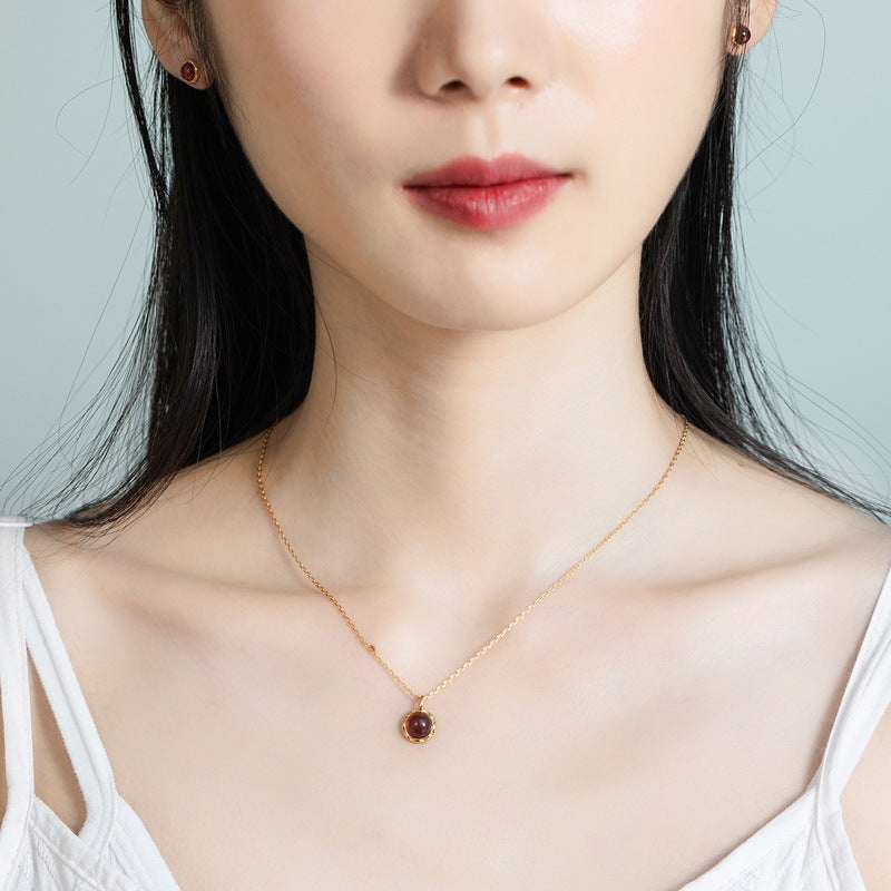 Origsoul necklace silver sterling with delicate chain and small red gemstone pendant worn by woman