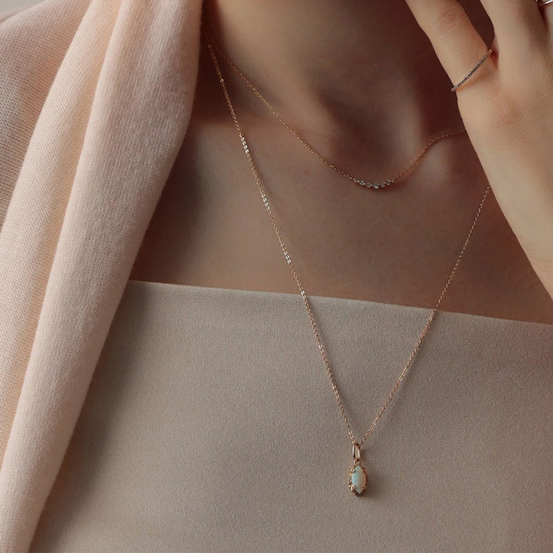 Origsoul delicate necklace silver sterling with pendant worn on model's neck with soft pink fabric