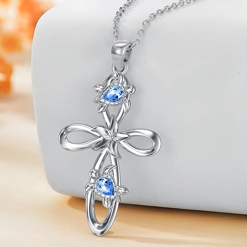 Origsoul ocean cross pendant necklace with silver floral design and blue gemstone accents
