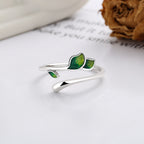 Origsoul delicate silver olive leaf ring with green enamel detailing on a white surface