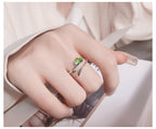 Origsoul delicate olive leaf ring with green enamel detailing worn on hand with light skin tone