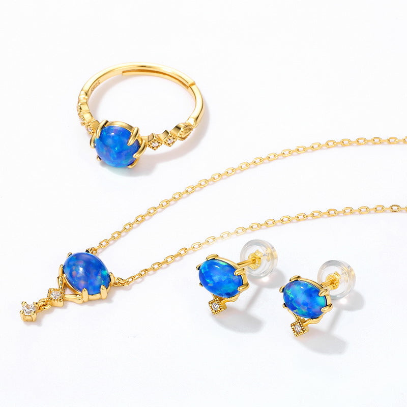 Origsoul gold jewelry set with blue opal stones featuring opal necklace birthstone ring and earrings