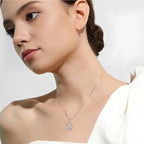 Origsoul ornate heart cross necklace worn by woman with elegant white top