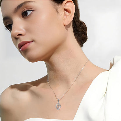 Origsoul ornate heart cross necklace worn by woman with elegant white top