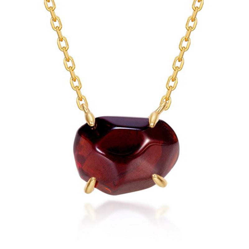 Origsoul pendant in sterling silver with deep red heart-shaped gemstone on gold chain