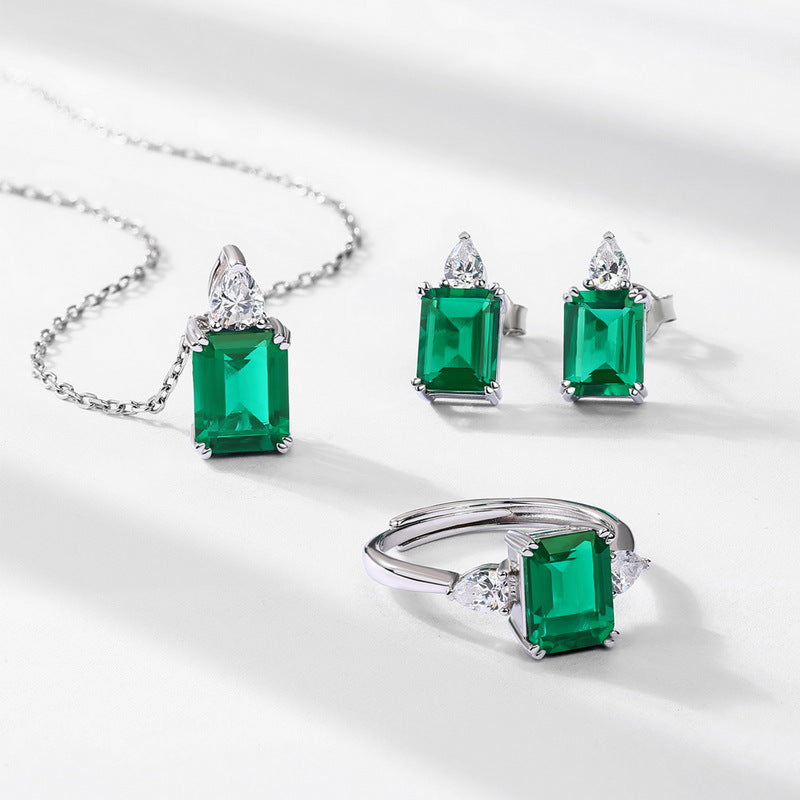 Origsoul jewelry set featuring pendant with emerald, matching earrings, and ring in silver