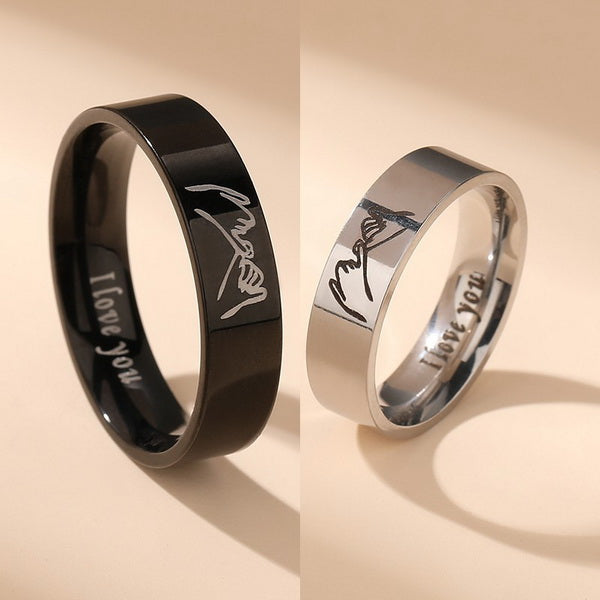 Origsoul personalized couples ring set with black and silver bands engraved with signatures and I love you message