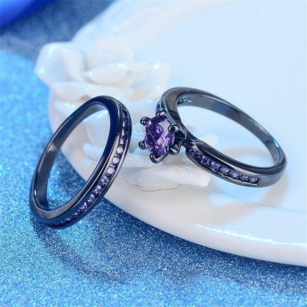 Origsoul premium diamond couple jewelry featuring black rings with purple stones on a glittery blue surface