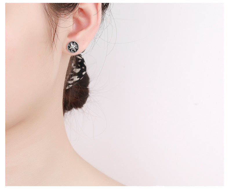 Origsoul retro black enamel earrings with cosmic star design worn on ear