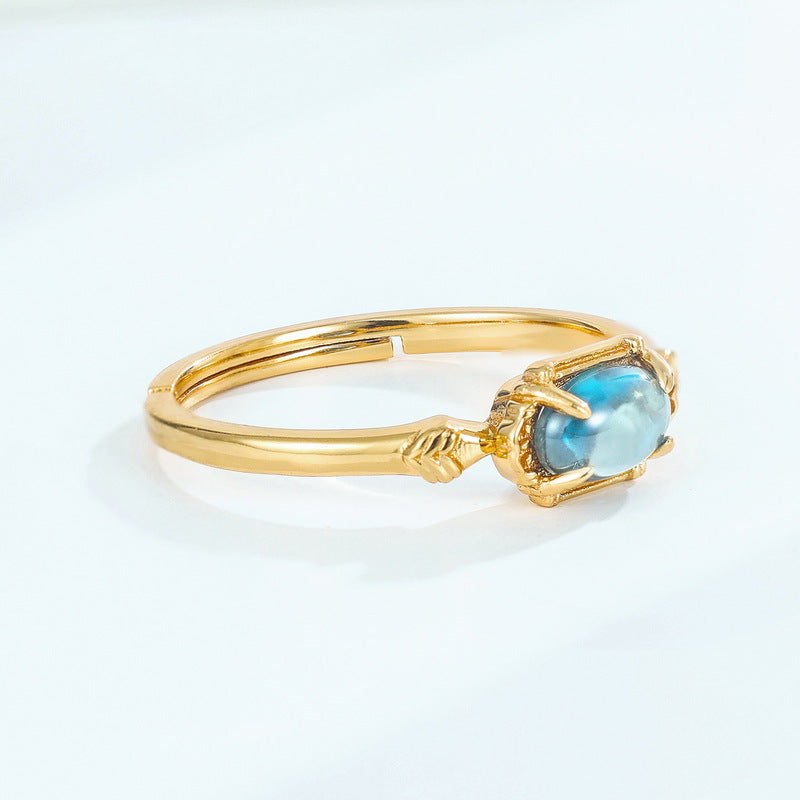 Origsoul gold tone ring sterling silver with blue oval gemstone and claw setting