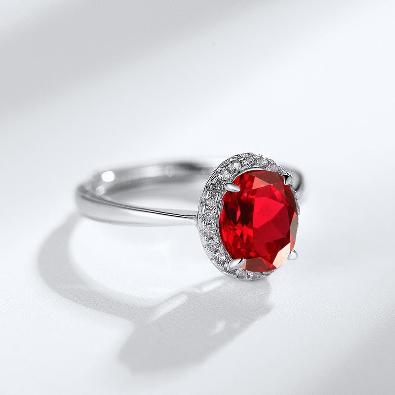 Origsoul ring sterling silver with large red gemstone and small surrounding crystals on white background