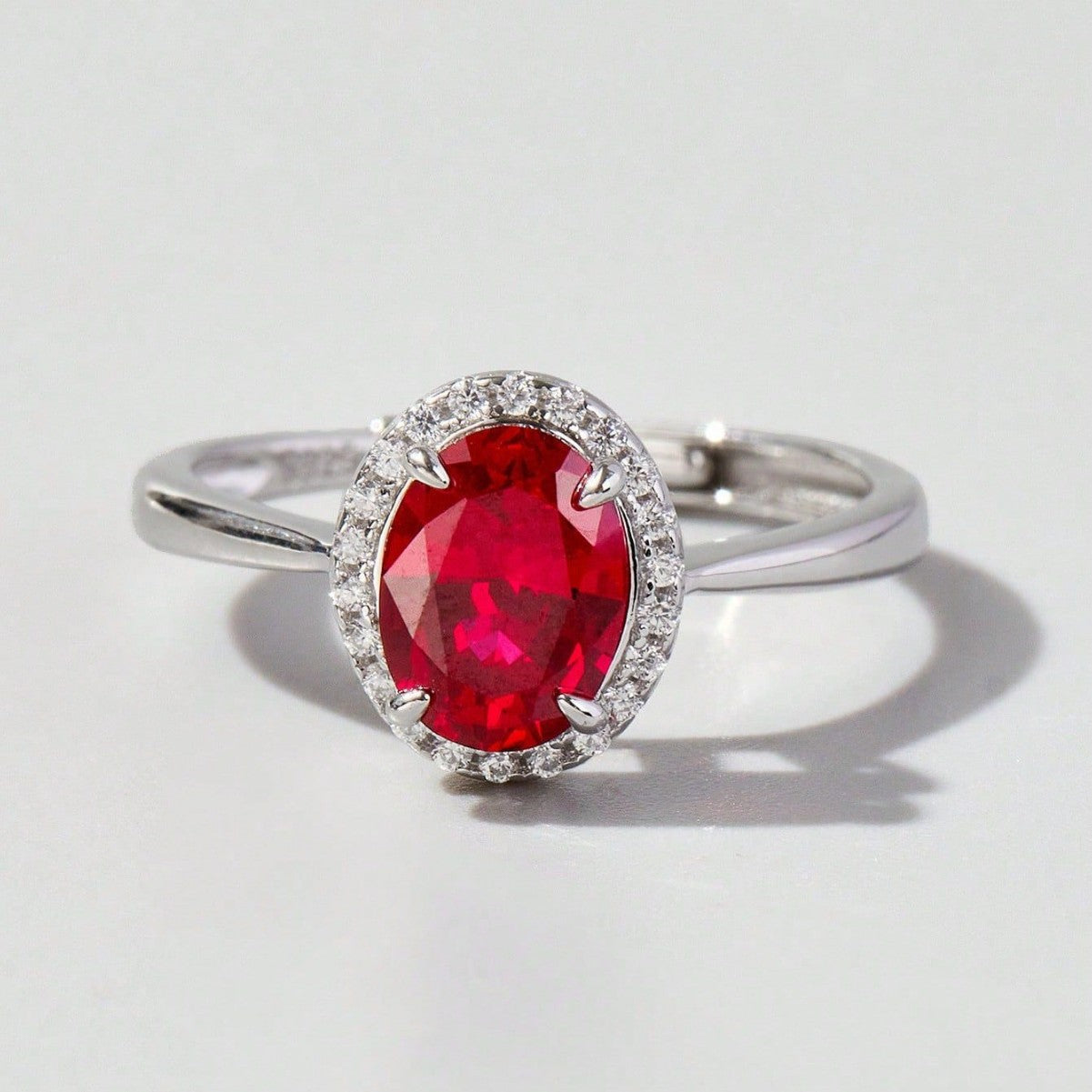 Origsoul ring sterling silver with oval red gemstone and small clear stones around the setting