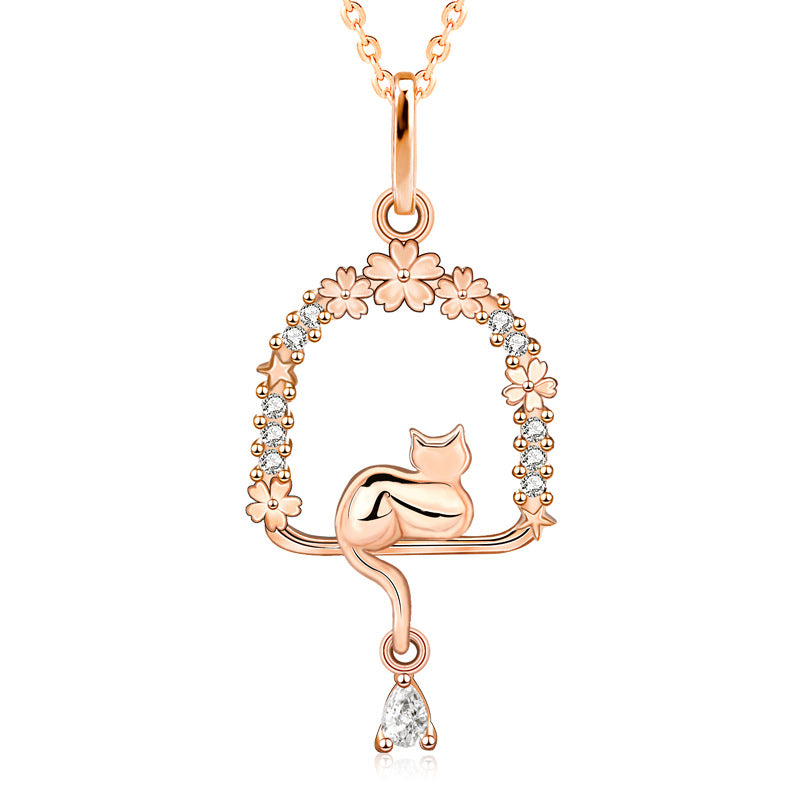 Origsoul rose gold cat necklace with floral and star accents and a dangling teardrop gem