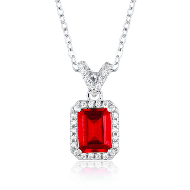 Origsoul jewelry featuring a silver chain with a red gemstone pendant and diamond accents emerald necklace