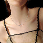 Delicate S925 sterling silver rose necklace worn by a model, enhancing an elegant outfit