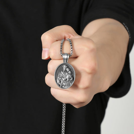Saint Joseph necklace pendant from Origsoul Tranquil Spirit Collection held in hand with detailed religious design